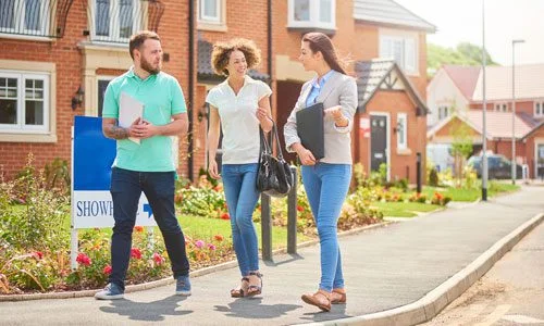 people walking looking at homes home buyers