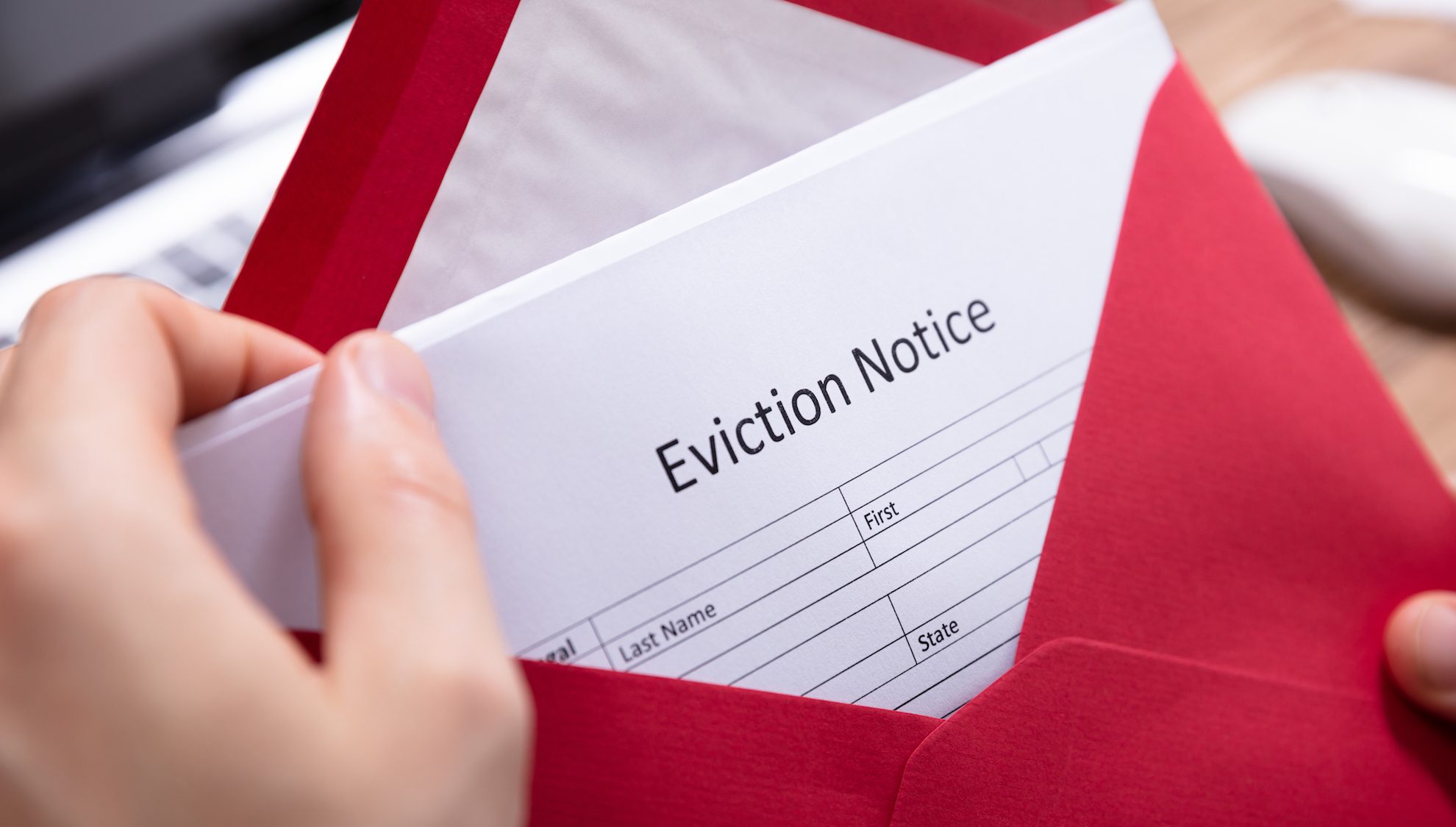 Person Holding Eviction Notice In Envelope