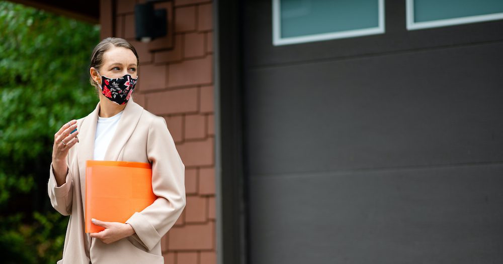 House Hunter woman looking to buy a home wearing a mask
