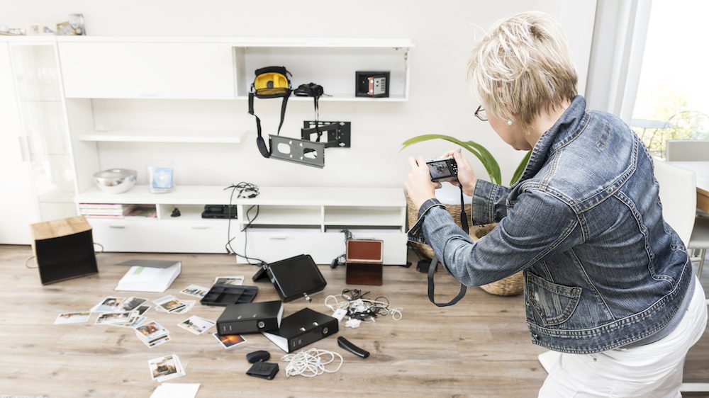 Woman photographing chaos after burglary when coming back in her one-family house