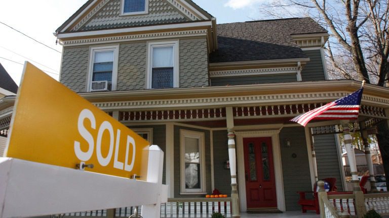 Home with sold sign in front
