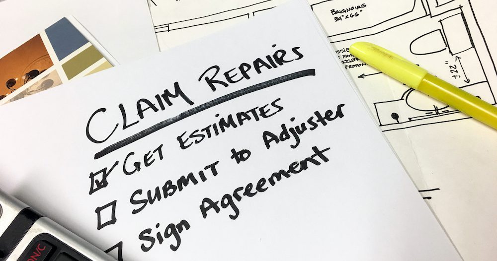 Insurance Claim Repairs and Payment Checklist Blueprints Calculator on Desk
