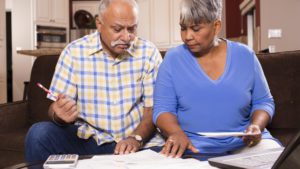 Senior couple paying monthly bills at home | Massachusetts Association of Buyer Agents Senior Couple