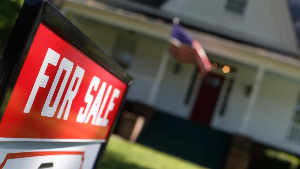 Home with for sale sign in front