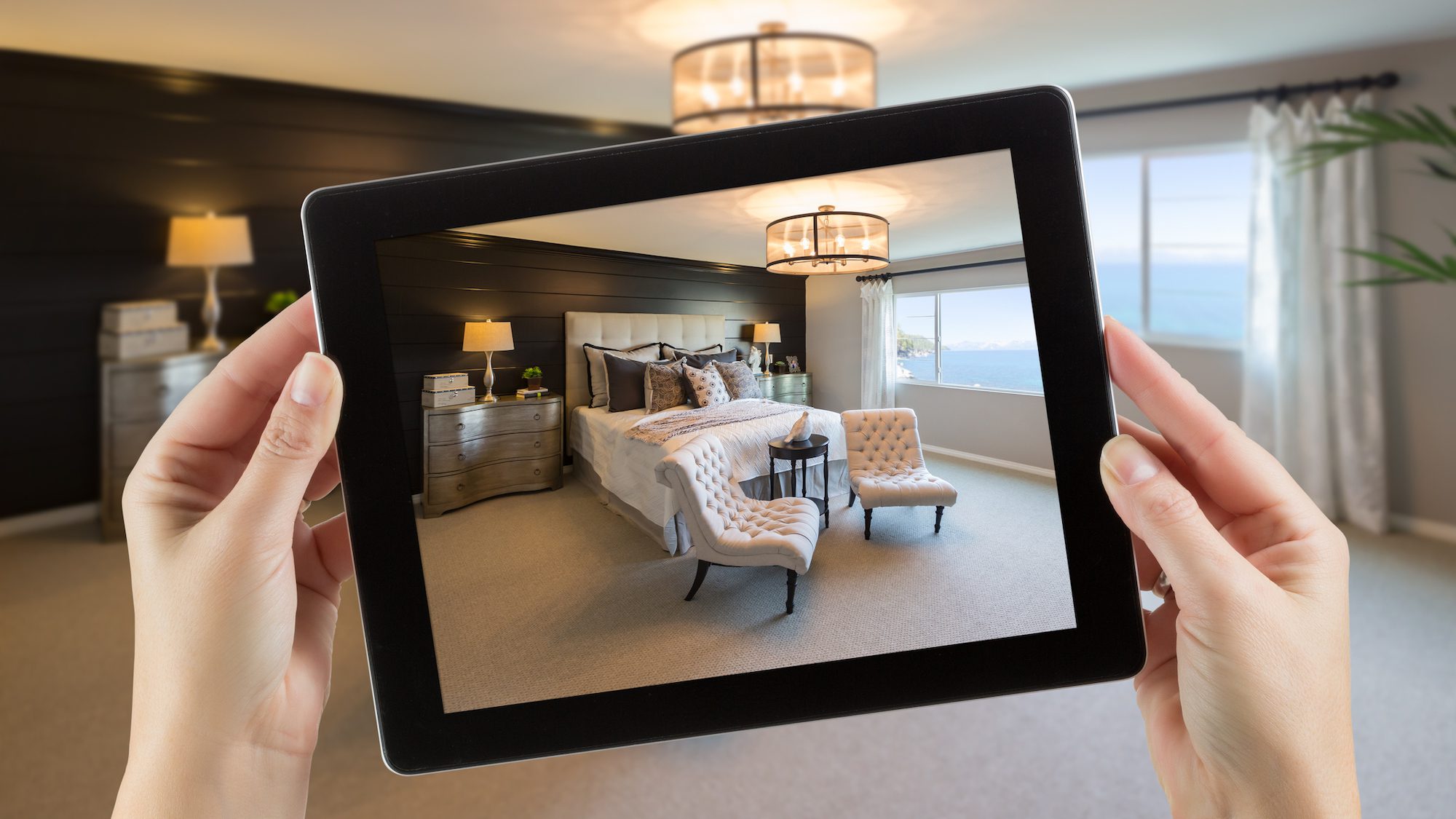 Female Hands Holding Computer Tablet In Room with Photo on Screen.