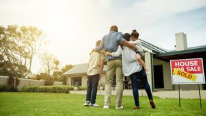 Shot of a family of four viewing their new home together