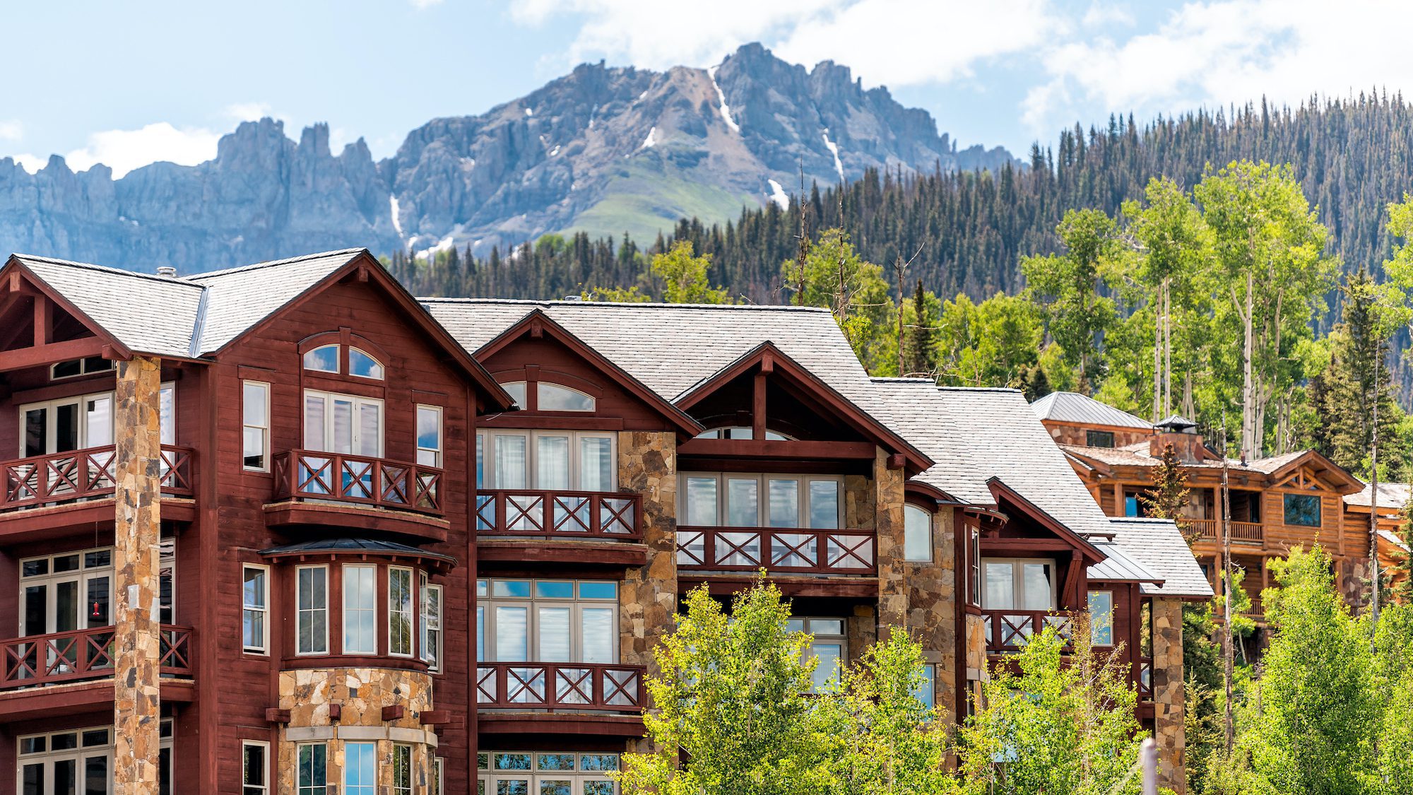 Telluride, Colorado small town Mountain Village in summer 2019 with view of San Juan Mountains and modern resort lodge apartment condo architecture